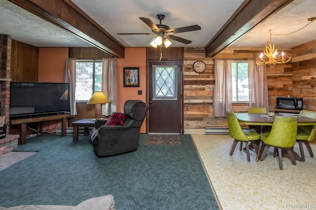 202 Redwine Dr, Houghton Lake, MI 48629 - living area featuring wood walls, a chandelier, plenty of natural light, ceiling fan, and beam ceiling