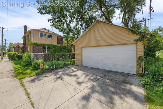 17617 Indiana St, Detroit, MI 48221 - view of front of home featuring a chimney, an outdoor structure, a detached garage, and brick siding