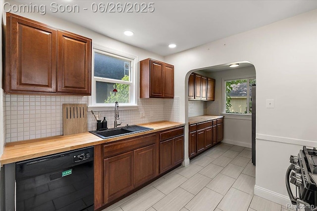 17617 Indiana St, Detroit, MI 48221 - kitchen with dishwasher, wood counters, arched walkways, tasteful backsplash, and light tile patterned floors