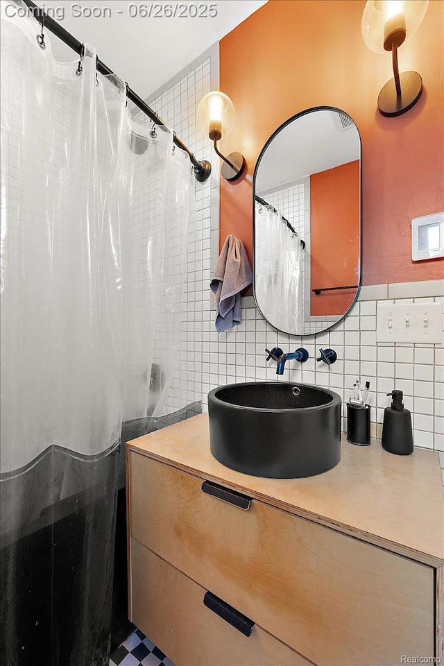 17617 Indiana St, Detroit, MI 48221 - full bathroom with vanity, decorative backsplash, tile walls, and a shower with shower curtain