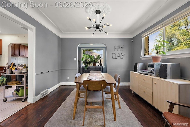 17617 Indiana St, Detroit, MI 48221 - dining space with a chandelier, arched walkways, and dark wood-style floors