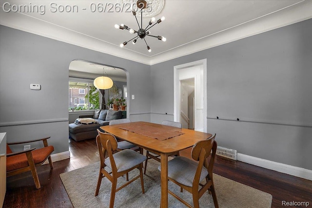 17617 Indiana St, Detroit, MI 48221 - dining area featuring arched walkways, a chandelier, and wood finished floors