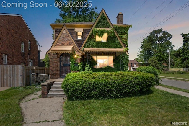 17617 Indiana St, Detroit, MI 48221 - tudor-style house featuring a chimney and brick siding