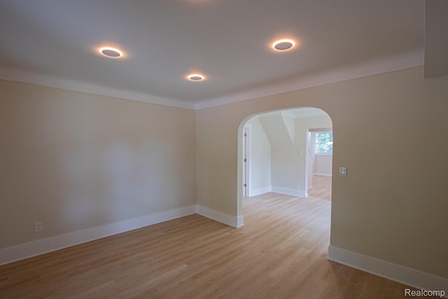 24917 Dale Ave, Eastpointe, MI 48021 - empty room featuring arched walkways and light wood-style flooring
