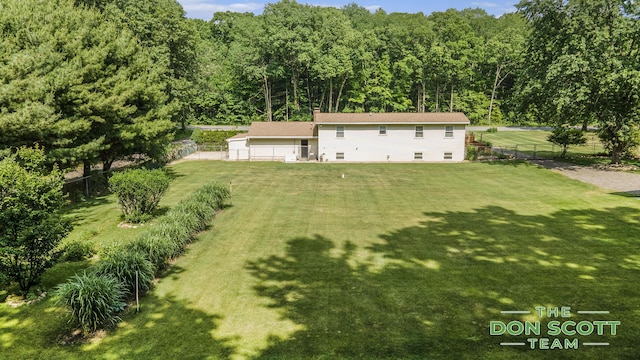 11829 Hoskins Ave NE, Cedar Springs, MI 49319 - rear view of house with a forest view and a chimney