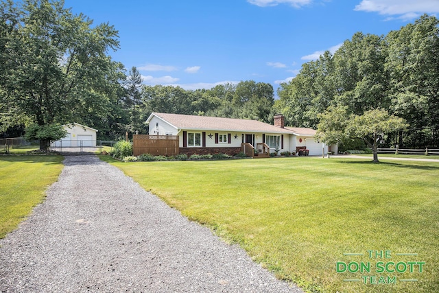 11829 Hoskins Ave NE, Cedar Springs, MI 49319 - single story home featuring a chimney, brick siding, a detached garage, and view of scattered trees
