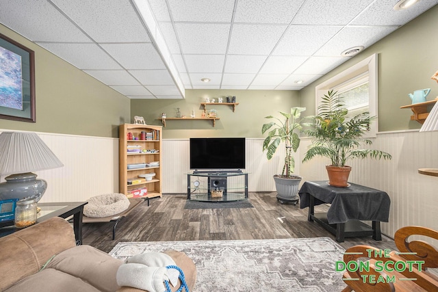 11829 Hoskins Ave NE, Cedar Springs, MI 49319 - living area with a wainscoted wall, wood finished floors, and a drop ceiling
