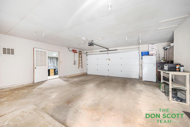 11829 Hoskins Ave NE, Cedar Springs, MI 49319 - garage featuring freestanding refrigerator and a garage door opener