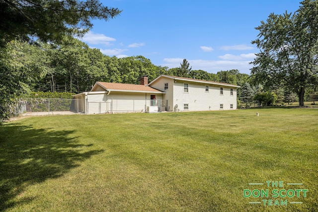 11829 Hoskins Ave NE, Cedar Springs, MI 49319 - rear view of property featuring a chimney
