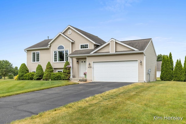 4233 Ives Farm Ln NE, Cedar Springs, MI 49319 - view of front of house with an attached garage, a front lawn, and driveway
