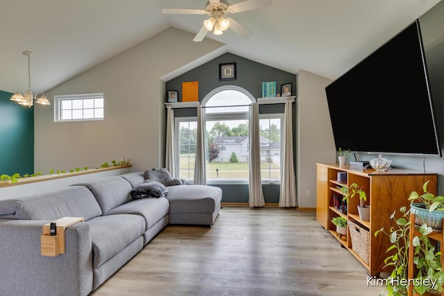 4233 Ives Farm Ln NE, Cedar Springs, MI 49319 - living room with lofted ceiling, light wood-style floors, a ceiling fan, and a chandelier