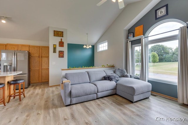 4233 Ives Farm Ln NE, Cedar Springs, MI 49319 - living room with a ceiling fan, light wood-type flooring, rail lighting, and high vaulted ceiling