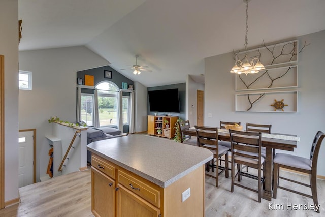 4233 Ives Farm Ln NE, Cedar Springs, MI 49319 - kitchen with light wood finished floors, ceiling fan, a center island, plenty of natural light, and lofted ceiling