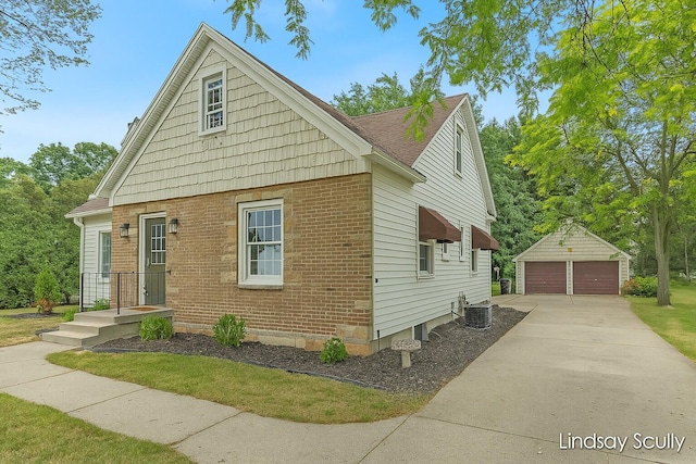 3976 Port Sheldon St, Hudsonville, MI 49426 - view of front of house with a detached garage, an outdoor structure, and brick siding