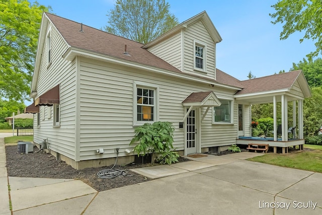 3976 Port Sheldon St, Hudsonville, MI 49426 - rear view of property featuring roof with shingles