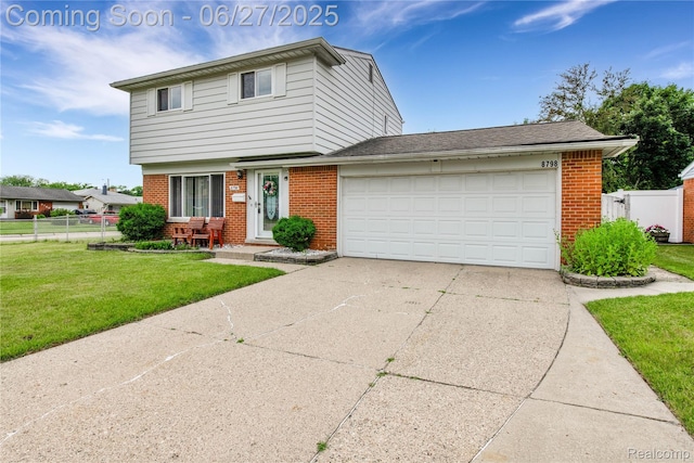 8798 Lozen Dr, Sterling Heights, MI 48313 - colonial-style house with brick siding, an attached garage, and concrete driveway