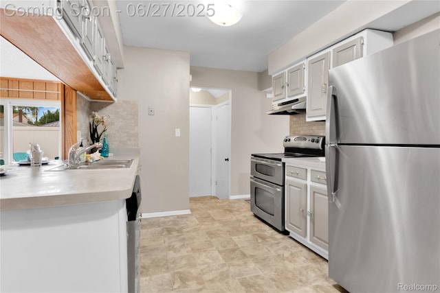 8798 Lozen Dr, Sterling Heights, MI 48313 - kitchen featuring appliances with stainless steel finishes, under cabinet range hood, decorative backsplash, and light countertops