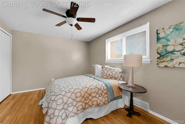 8798 Lozen Dr, Sterling Heights, MI 48313 - bedroom featuring wood finished floors, a closet, and a ceiling fan