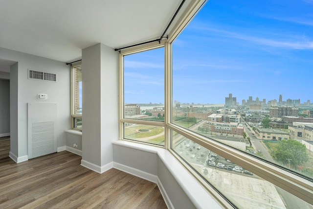 3320 Spinnaker Ln Unit 16D, Detroit, MI 48207 - unfurnished sunroom featuring a view of skyline and a heating unit