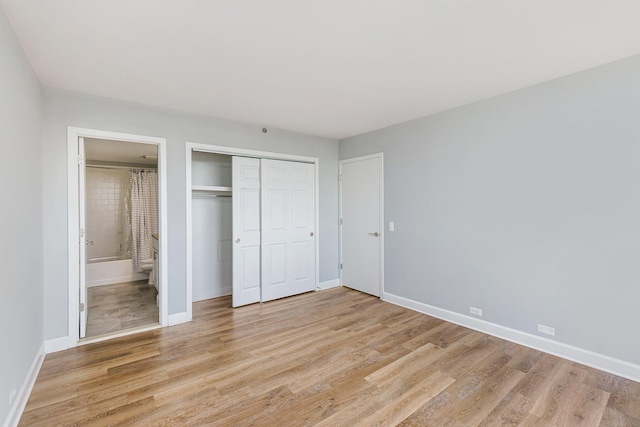 3320 Spinnaker Ln Unit 16D, Detroit, MI 48207 - unfurnished bedroom with light wood-style flooring, a closet, and ensuite bathroom