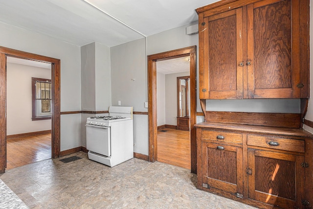 941 Mcreynolds Ave NW, Grand Rapids, MI 49504 - kitchen with white gas stove and brown cabinets