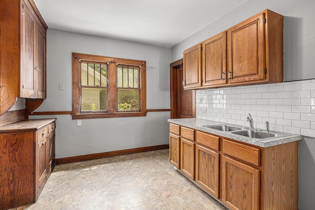 941 Mcreynolds Ave NW, Grand Rapids, MI 49504 - kitchen featuring tasteful backsplash, brown cabinetry, and light countertops