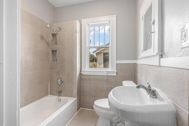941 Mcreynolds Ave NW, Grand Rapids, MI 49504 - full bathroom with bathing tub / shower combination, tile patterned flooring, tile walls, and a wainscoted wall