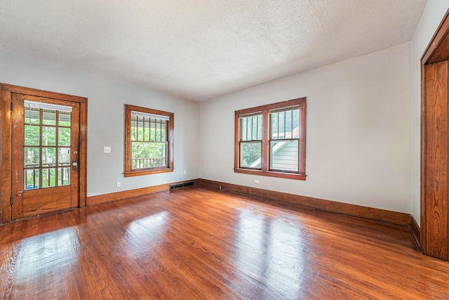 941 Mcreynolds Ave NW, Grand Rapids, MI 49504 - spare room featuring wood finished floors and a textured ceiling