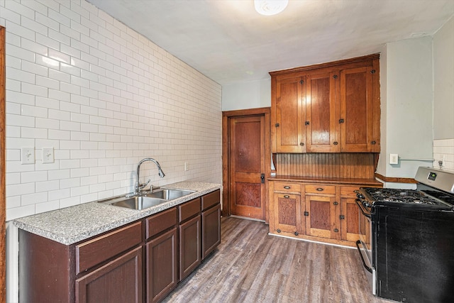 941 Mcreynolds Ave NW, Grand Rapids, MI 49504 - kitchen with stainless steel gas range, light wood-style floors, tasteful backsplash, tile walls, and light countertops