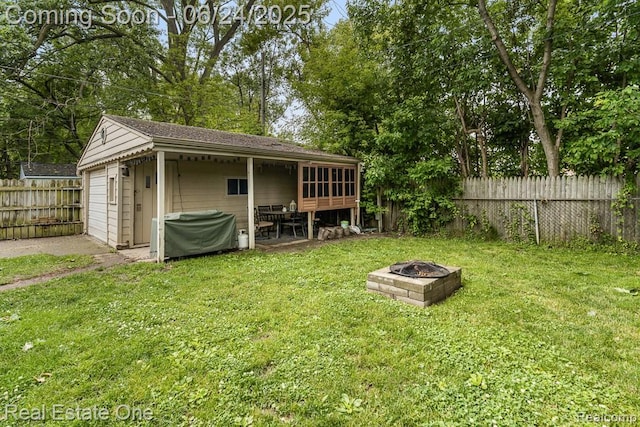 25893 Firwood Ave, Warren, MI 48089 - fenced backyard with an outdoor fire pit and a detached garage