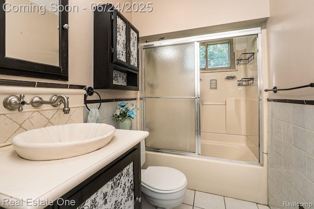 25893 Firwood Ave, Warren, MI 48089 - bathroom with tile walls, vanity, bath / shower combo with glass door, and tile patterned floors