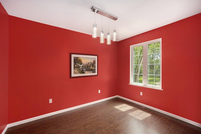1156 N Bridge St, Linden, MI 48451 - spare room featuring dark wood-type flooring and baseboards