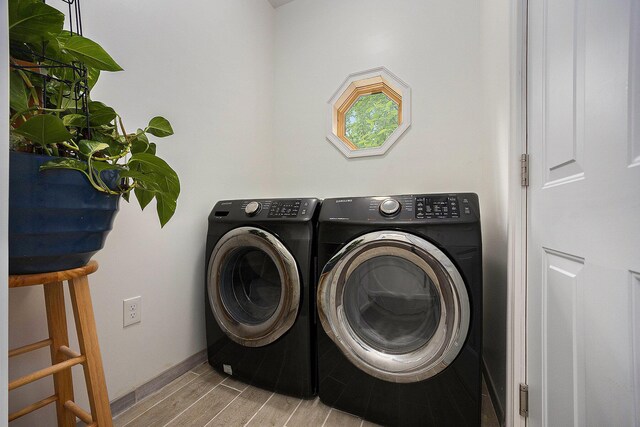 1156 N Bridge St, Linden, MI 48451 - laundry area featuring washer and clothes dryer and wood finished floors