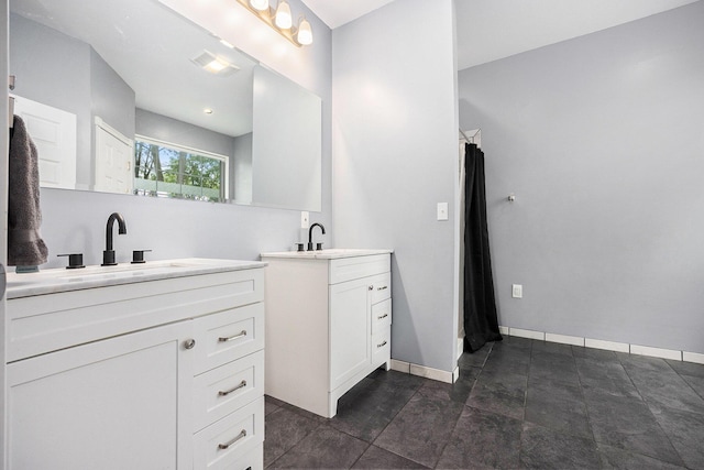 1156 N Bridge St, Linden, MI 48451 - bathroom featuring two vanities and baseboards