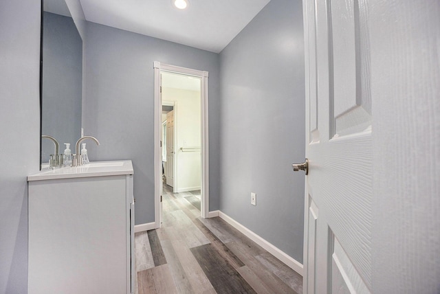 1156 N Bridge St, Linden, MI 48451 - bathroom featuring wood finished floors, vanity, and recessed lighting