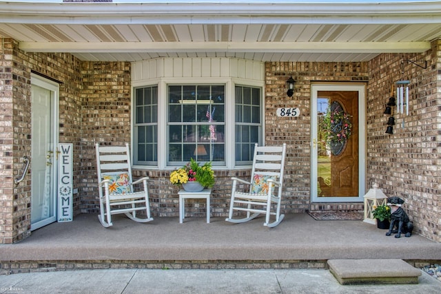845 Riverlane Dr, Owosso, MI 48867 - view of exterior entry featuring covered porch and brick siding