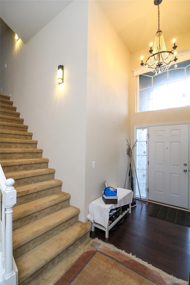 30475 Berghway Trl, Warren, MI 48092 - foyer with stairs, a chandelier, wood finished floors, and high vaulted ceiling