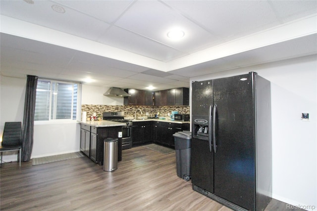 30475 Berghway Trl, Warren, MI 48092 - kitchen featuring stainless steel gas stove, black refrigerator with ice dispenser, wood finished floors, and tasteful backsplash
