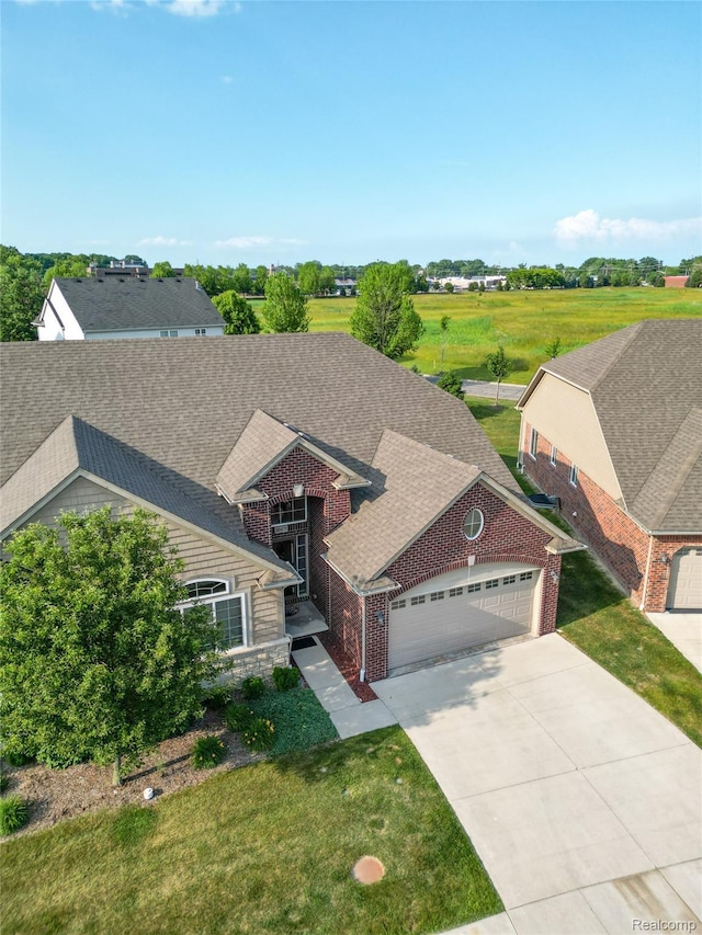 30475 Berghway Trl, Warren, MI 48092 - view of front facade with an attached garage, driveway, a front yard, and roof with shingles
