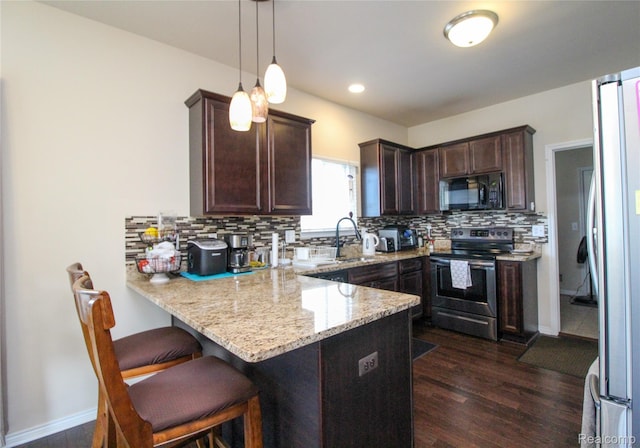 30475 Berghway Trl, Warren, MI 48092 - kitchen with appliances with stainless steel finishes, a peninsula, dark brown cabinets, backsplash, and dark wood-type flooring