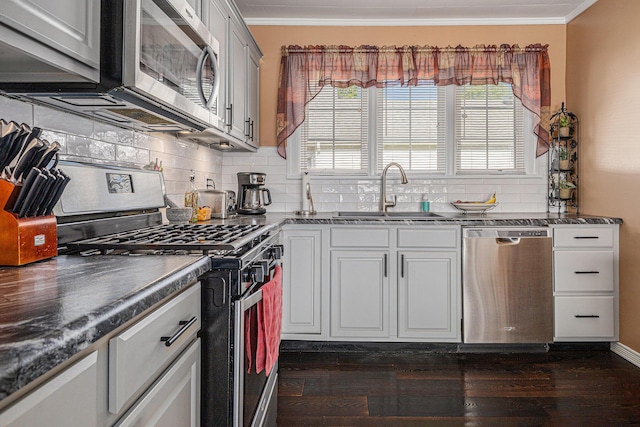 209 Maple St, Three Oaks, MI 49128 - kitchen featuring stainless steel appliances, ornamental molding, decorative backsplash, and dark wood-style flooring