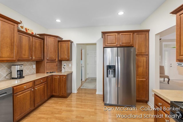 1809 Woodside Trl NW, Grand Rapids, MI 49504 - kitchen featuring stainless steel appliances, light wood finished floors, tasteful backsplash, light countertops, and recessed lighting