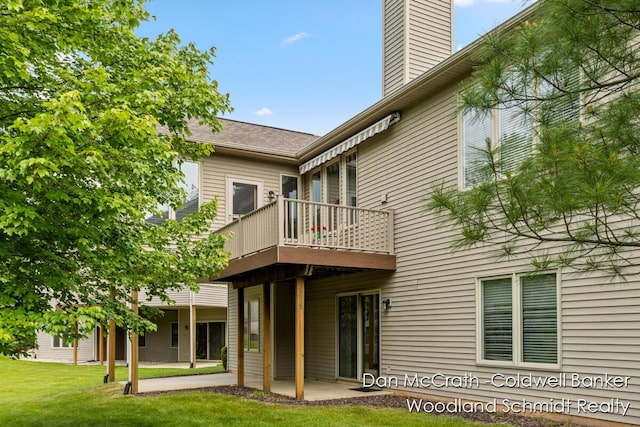 1809 Woodside Trl NW, Grand Rapids, MI 49504 - back of property with a chimney, a patio area, a lawn, and a wooden deck