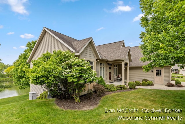 1809 Woodside Trl NW, Grand Rapids, MI 49504 - view of front of home featuring a front lawn, roof with shingles, and a water view
