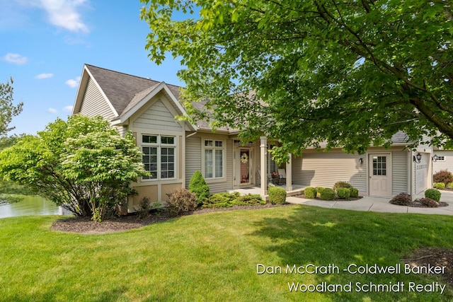 1809 Woodside Trl NW, Grand Rapids, MI 49504 - obstructed view of property featuring a front lawn, a water view, and a shingled roof