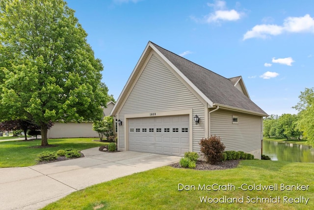 1809 Woodside Trl NW, Grand Rapids, MI 49504 - view of property exterior with concrete driveway, a yard, roof with shingles, a garage, and a water view