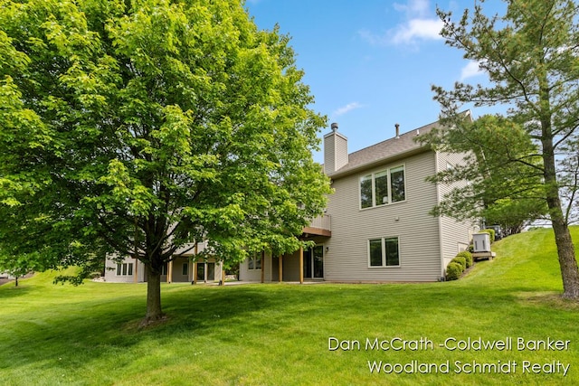 1809 Woodside Trl NW, Grand Rapids, MI 49504 - rear view of house with a chimney and a lawn