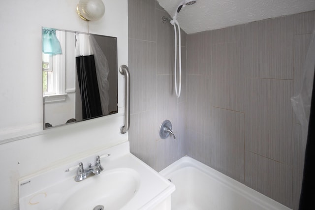 246 Powell St SE, Grand Rapids, MI 49507 - bathroom with tub / shower combination, vanity, and a textured ceiling