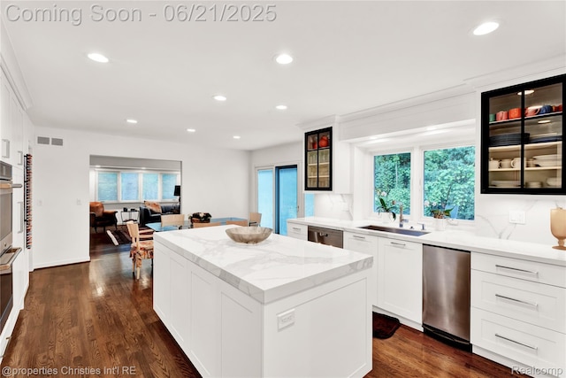 4768 Wendrick Dr, West Bloomfield, MI 48323 - kitchen featuring a kitchen island, recessed lighting, appliances with stainless steel finishes, glass insert cabinets, and light stone countertops