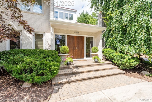 4768 Wendrick Dr, West Bloomfield, MI 48323 - doorway to property featuring a chimney and brick siding